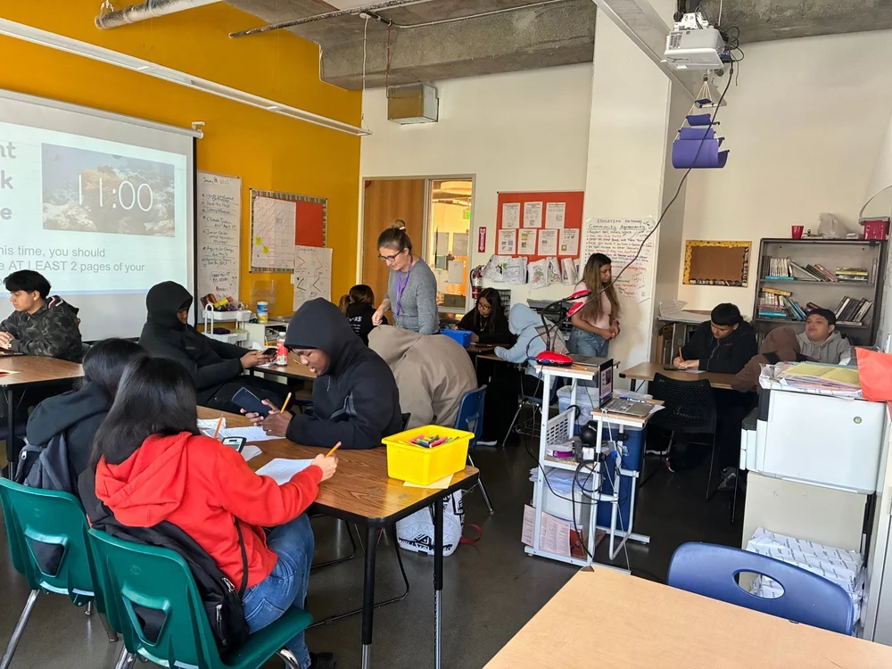 An ARISE math teacher checking in with students as they work