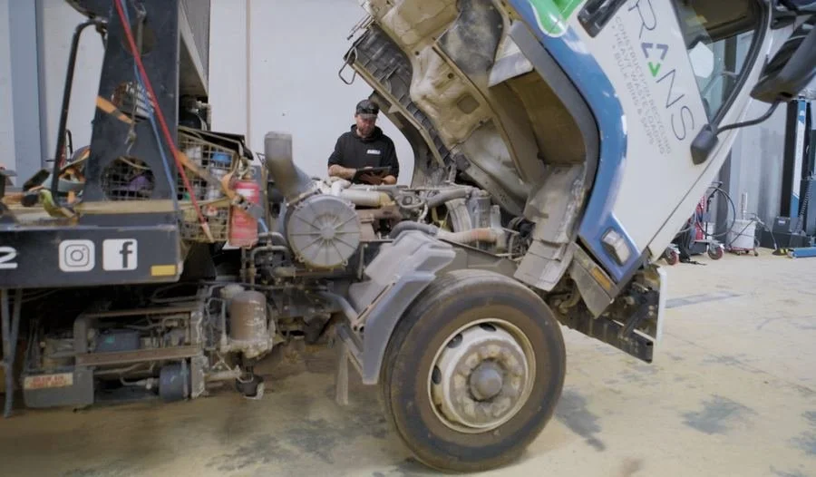 Fleet360 mechanic servicing a truck with the cab tilted